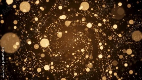 swirling golden particles with bokeh in dark background