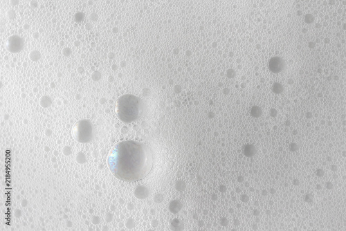 Abstract background white soapy foam texture. Shampoo foam with bubbles