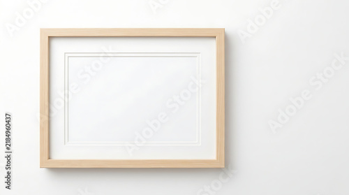 Empty wooden picture frame mockup on a clean white wall background