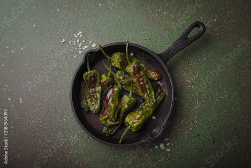 Padron peppers fried cast iron skillet sea salt dark green background Spanish appetizer top view