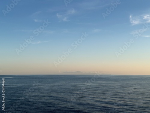 France, Cap Corse seen from cruise ship balcony on summer evening to Naples, Italy - Pastel Ligurian Mediterranean Sea after sunset