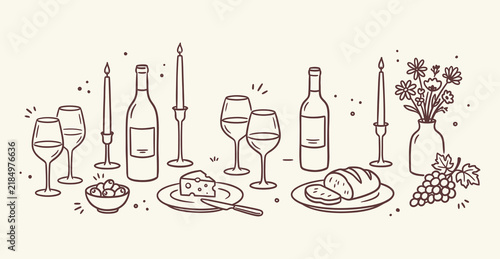 Dinner party table setting with wine bottles cheese and bread