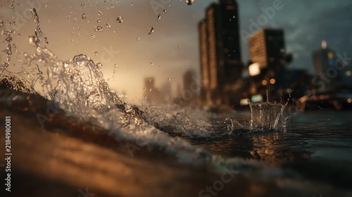 Close up of splashing water waves on flooded city street sunset cinematic