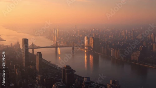 Aerial view of large city bridge covered in thick golden smog sunset cinematic