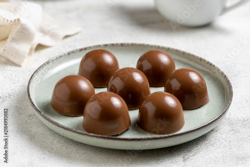 Gourmet Milk Chocolate Bonbons and Chocolate Truffles on Ceramic Plate