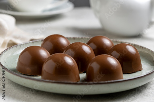 Gourmet Milk Chocolate Bonbons and Chocolate Truffles on Ceramic Plate