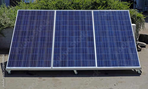 Foto Portable Photovoltaic Solar Panel at Angle Power Modules With Wheels Sunny Day