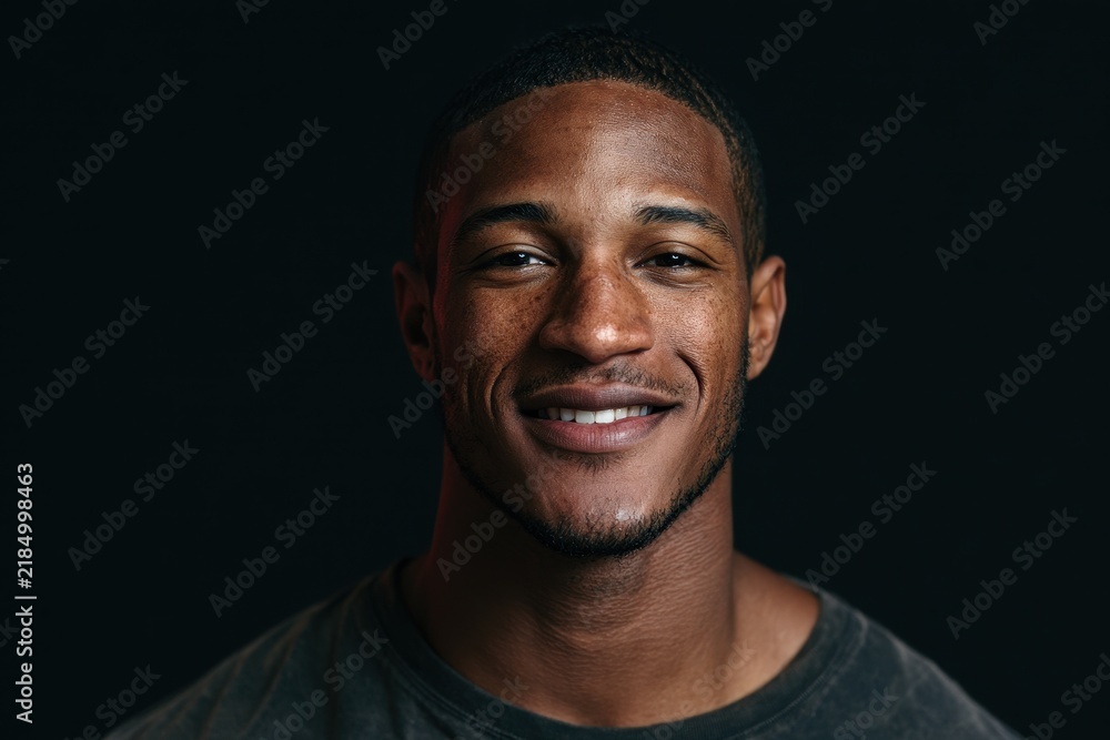 Obraz premium Confident male portrait in soft studio lighting on a black background