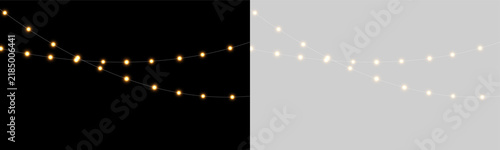 Obraz na płótnie A string of warm yellow fairy lights appear softly glowing against a deep black background