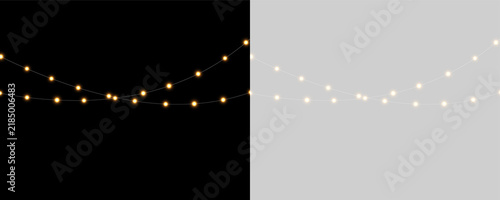 A set of warm glowing string lights with soft halo effects. The lights are suspended in two parallel horizontal lines against a black background. These lights create a cozy and festive.