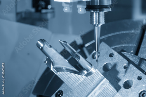 Finish cutting of a mold insert by a ball nose end mill on a 5-axis CNC machine in blue tone