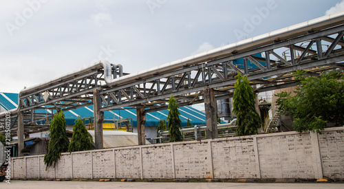 Canvastavla Industrial steel pipe rack system on factory wall in chemical manufacturing plant