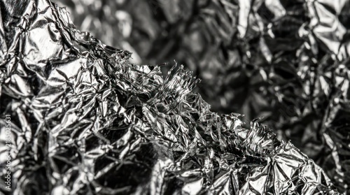 Close up of crumpled metallic foil texture with reflective highlights