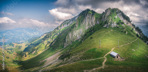 Scenic mountain ridge trail with a small hut in the Swiss Alps