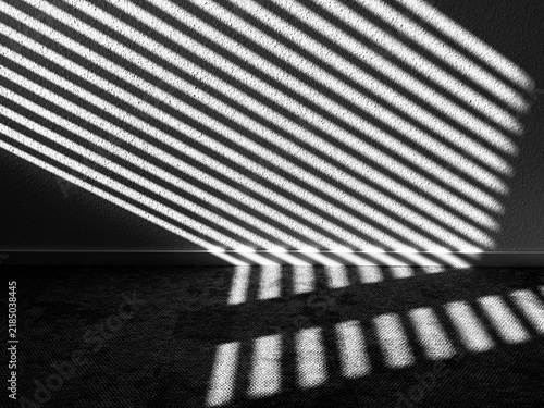 Abstract black-and-white photograph featuring parallel bands of light and shadow