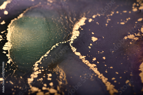 Abstract background of purple-green and gold stains. Photo of the surface.