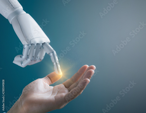 Obraz na płótnie 人の手のひらに触れるロボットの指先と光で表現したAIと人間の協働