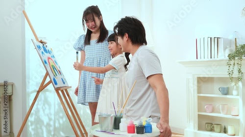 Girl Paints With Family in Home as They Enjoy Creative Education Time Together
