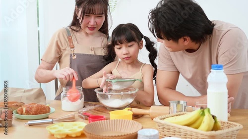 Family Cooking Together in a Kitchen While Making Dessert on a Weekend Morning