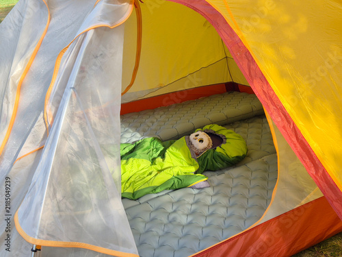 Spacious tourist tent interior with mosquito net entrance and sleeping bag