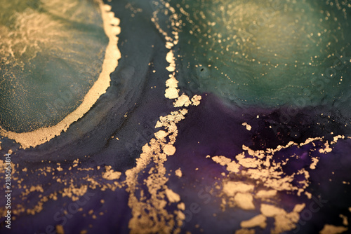 Abstract background of purple-green and gold stains. Close-up photo.