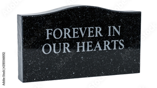 Фотография Black granite headstone with engraved text FOREVER IN OUR HEARTS , isolated on t