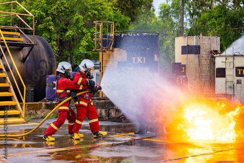 Firefighters extinguishing flames at industrial site