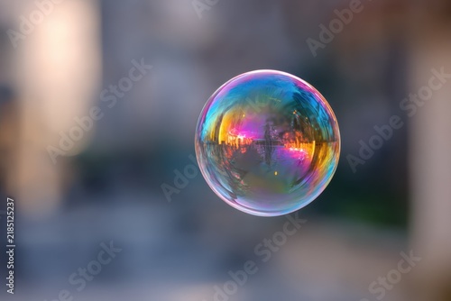 Soap bubble reflecting a vibrant city skyline at sunset