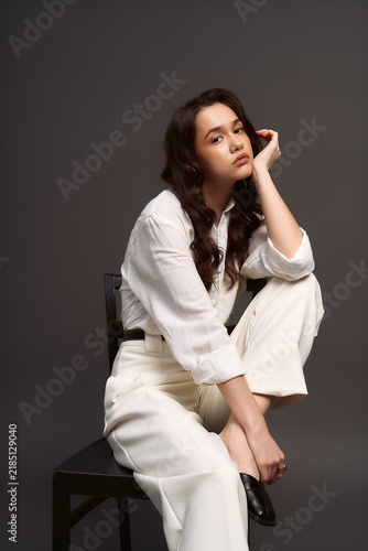 Bild auf Leinwand Stunning young woman displays effortless style in chic monochrome fashion