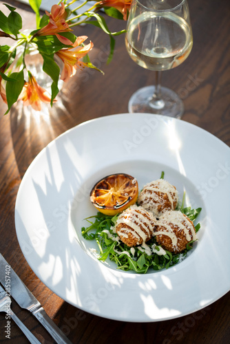 Delicious Gourmet Dish Served Elegantly With Wine and Flowers