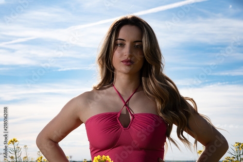 Woman in Fuchsia Dress Under a Blue Sky