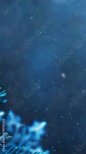 This image evokes a serene winter ambiance with focus on frosted pine needles and delicate snowflakes against a blue backdrop, suggesting peace and festivity.