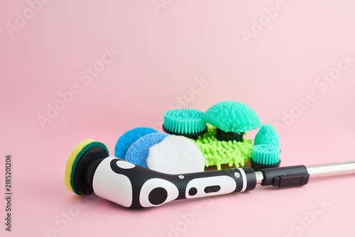 Electric spin scrubber with various brush heads on pink