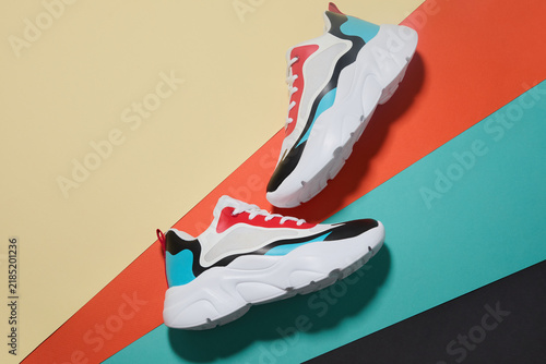 Colorful chunky sneakers on geometric color blocking background