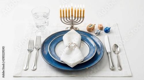 Obraz na płótnie Hanukkah table setting with menorah and blue plates