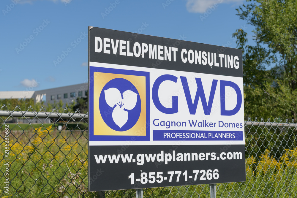 Fototapeta premium GWD (Gagnon Walker Domes) development consulting sign on a wire mesh fence, Eglinton Av E, Toronto