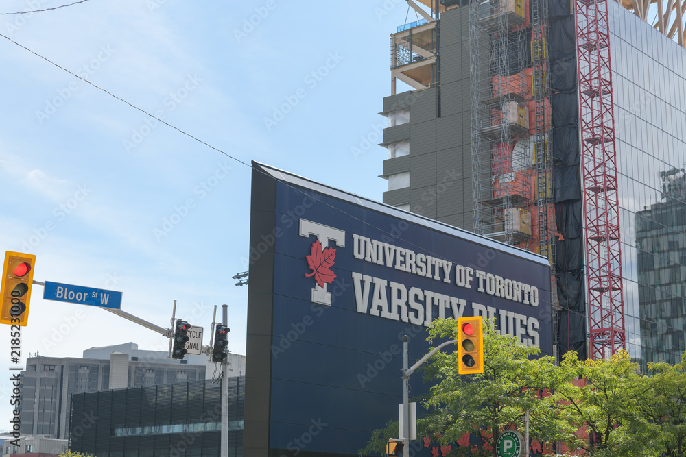 Fototapeta premium sign at Varsity Centre and view of Academic Wood Tower located at 100 Devonshire Place, University of Toronto, St George Campus