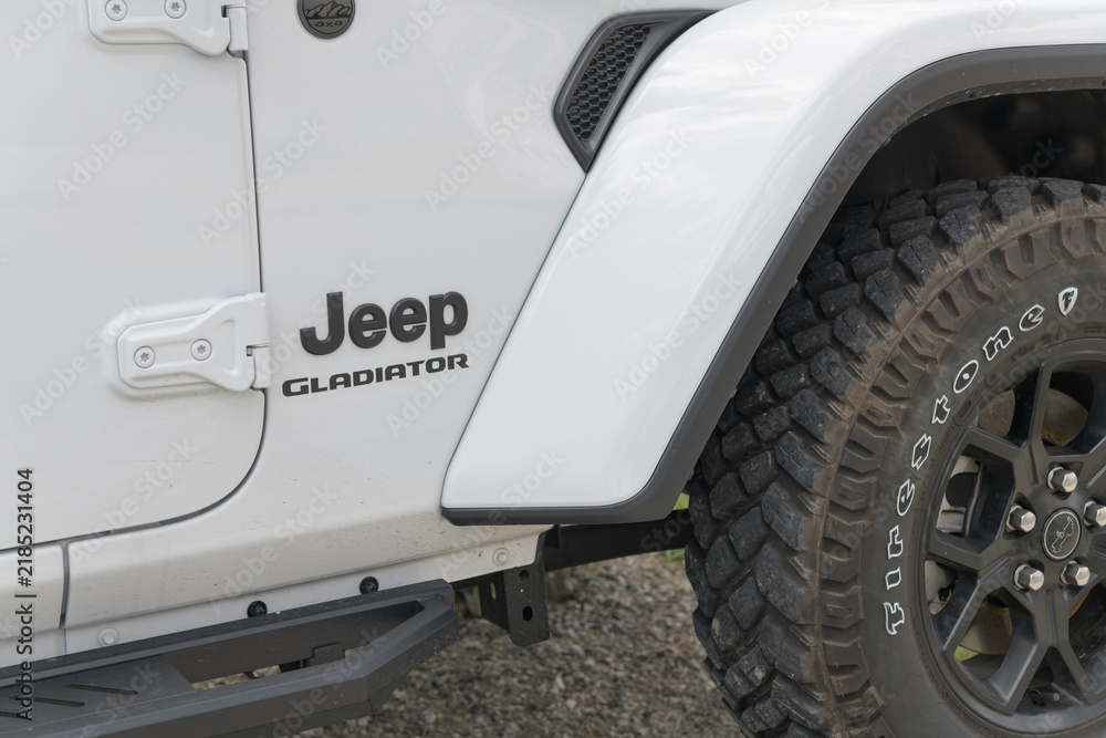 Fototapeta premium Firestone tire and Jeep Gladiator model badge on the side of a vehicle in Toronto