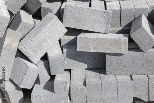 gray blocks or pavers in a messy pile outdoors