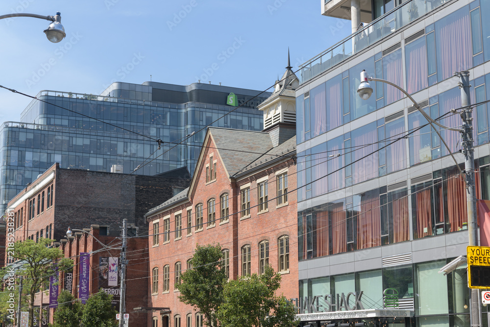 Obraz premium looking west on King St W (north side) to Shake Shack (556 King St W) and The Keg Steakhouse + Bar (560 King St W), and other structures incl an office building, Toronto