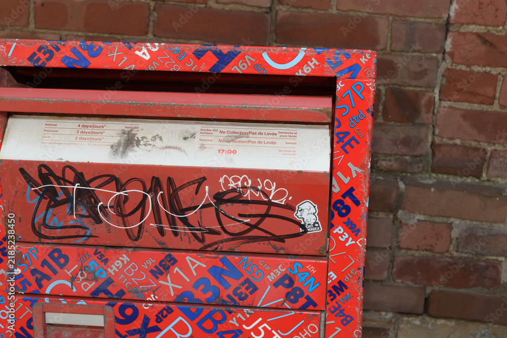 Fototapeta premium brick wall and Canada Post street letter box front side with flap (postal-code wrap), Toronto