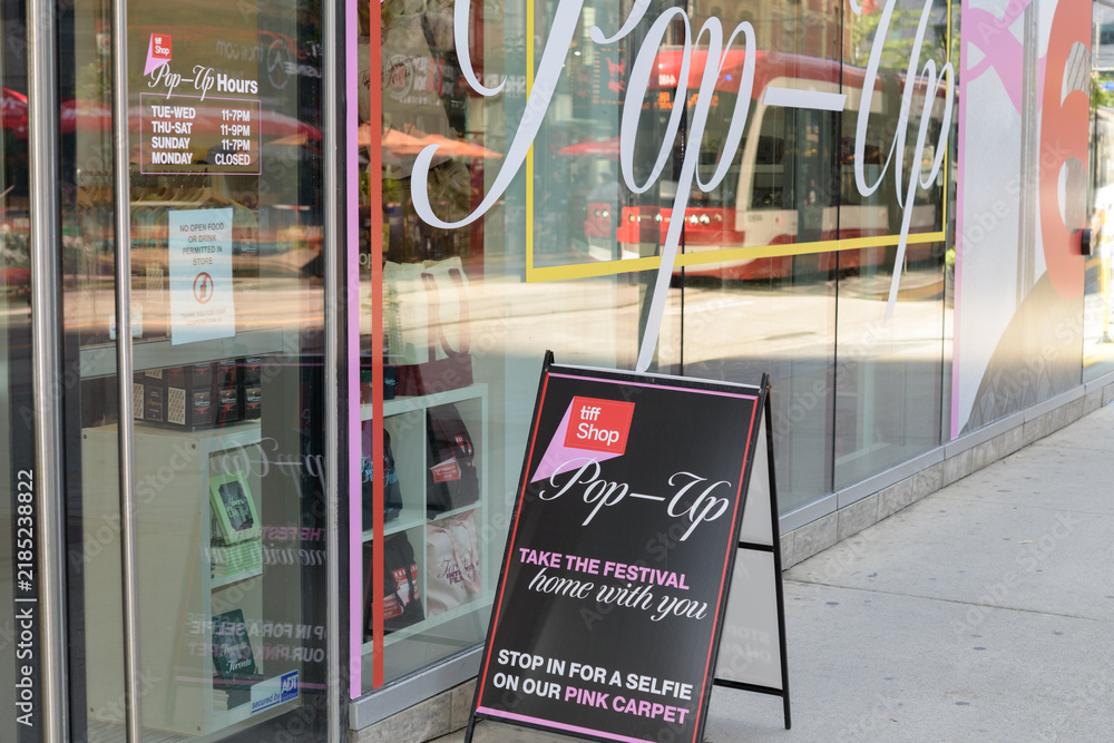 Fototapeta premium sidewalk a-frame poster sign and exterior of TIFF Lightbox, a movie theatre, located at 350 King St W, Floor 1 of the Festival Tower, Toronto