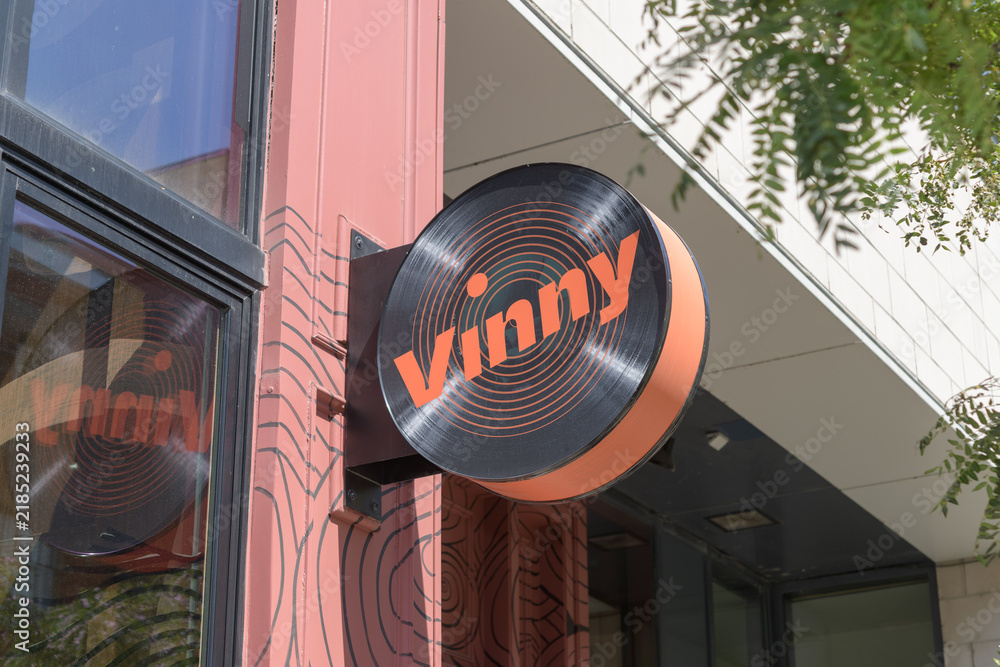 Fototapeta premium wall-mounted projecting circle sign of Vinny Toronto - Restaurant & Vinyl Bar, located at 480 King St W