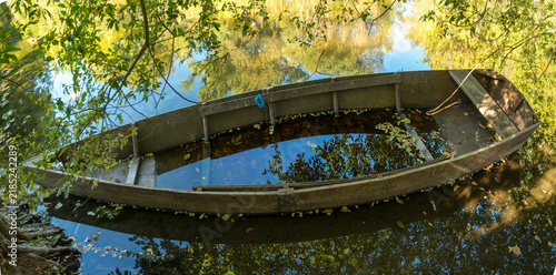 France, Dordogne, Carennac.  Sunken small watercraft on the side of the Dordogne River.
