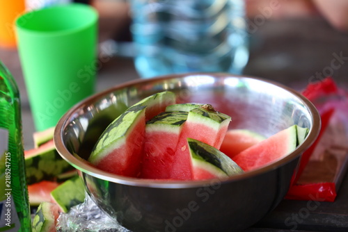 Fresh Watermelon Slices in Metal Bowl on Picnic Table
