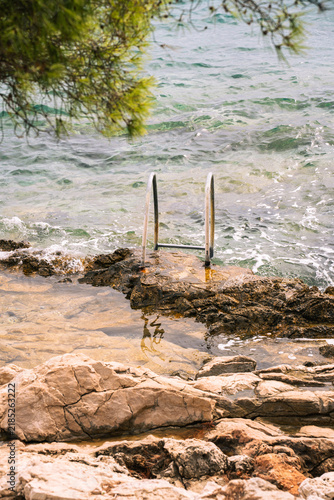 Фотография Swimming ladder on a rocky shore with turquoise sea in Hvar