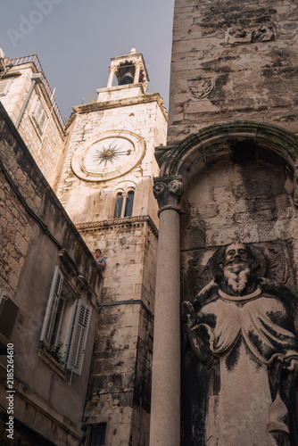 Фотография Stone clock and saint statue on a historic church in Split