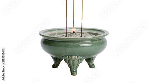 фотографія Isolated three burning incense sticks in a traditional green ceramic censer pot for spiritual ritual