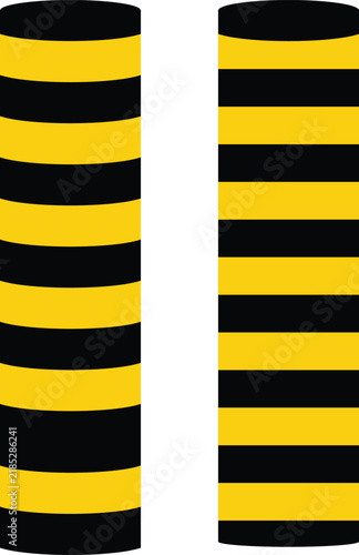 Two cylindrical bollards with alternating yellow and black stripes appear as a stark silhouette barrier post guard protection safety contrast warning hazard parking security road