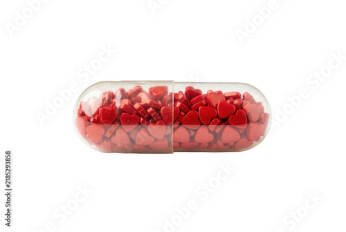 Clear capsule filled with shiny red heart shaped pills on black background